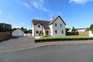 The exterior shot showing the front of Rockfield Park. A detached, two storey family home in Lisbane. Well maintained gardens are seen to the front of the property. A spacious driveway and double detached garage can be seen to the left of the property.