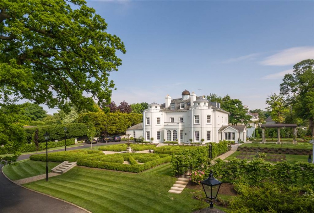 The exterior of 25 Cultra Avenue. Beautiful, well-maintained gardens are seen with an array of plants and trees. Image used in the Luxury Living: Stylish homes for sale in Northern Ireland blog post.