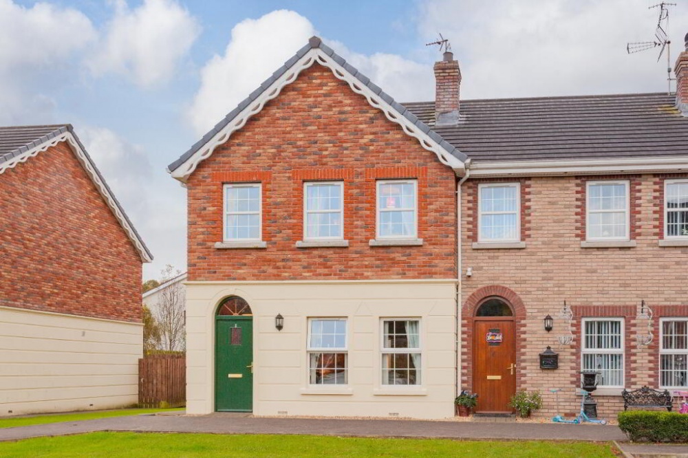 The exterior of 7 Glencairne. This is an end townhouse for sale in Dungannon. Neat gardens can be seen to the front of the property. Image used in the Stocking fillers: Top 10 homes for sale under 115k blog post.