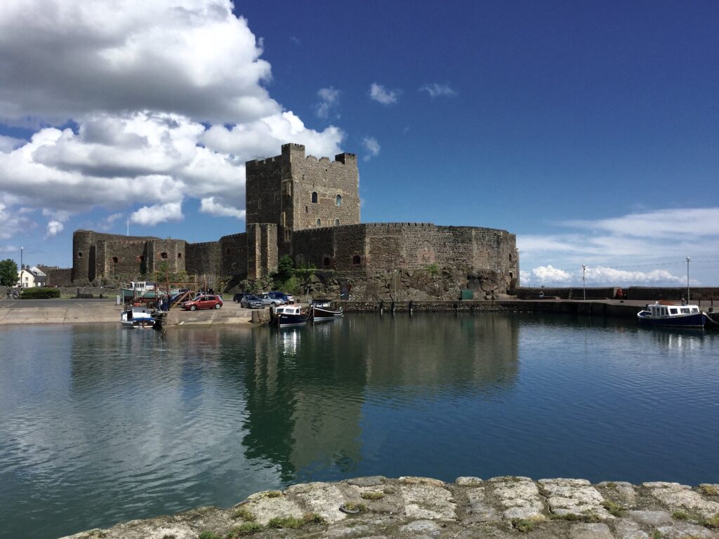 Exterior of Carrickfergus Castle. Boats can be seen in the water surrounding the castle.
