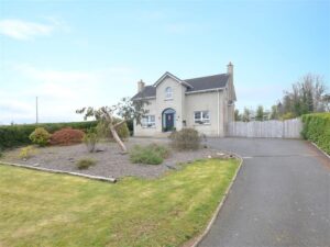 Exterior of Hillhall Road, a home for sale in Lisburn, This house rests in a semi-rural area on an extensive, private plot. A tarmac driveway leads to the front of the house. Neat gardens are also seen to the front of the house.