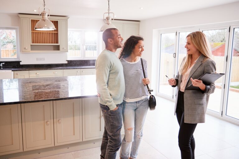 Estate agent showing a couple around a house. Image used in the Top tips for viewing a house - the complete guide blog