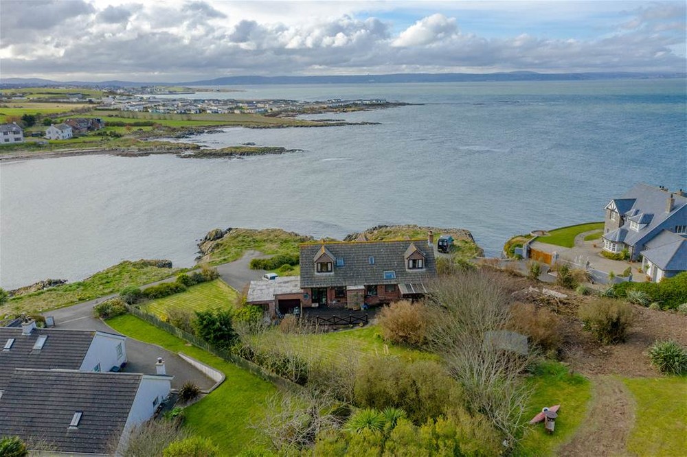 The exterior of 11 Sandeel Lane, a detached home that rests on the coastline in Groomsport. Image used in the 10 dream houses for sale in Northern Ireland blog post.