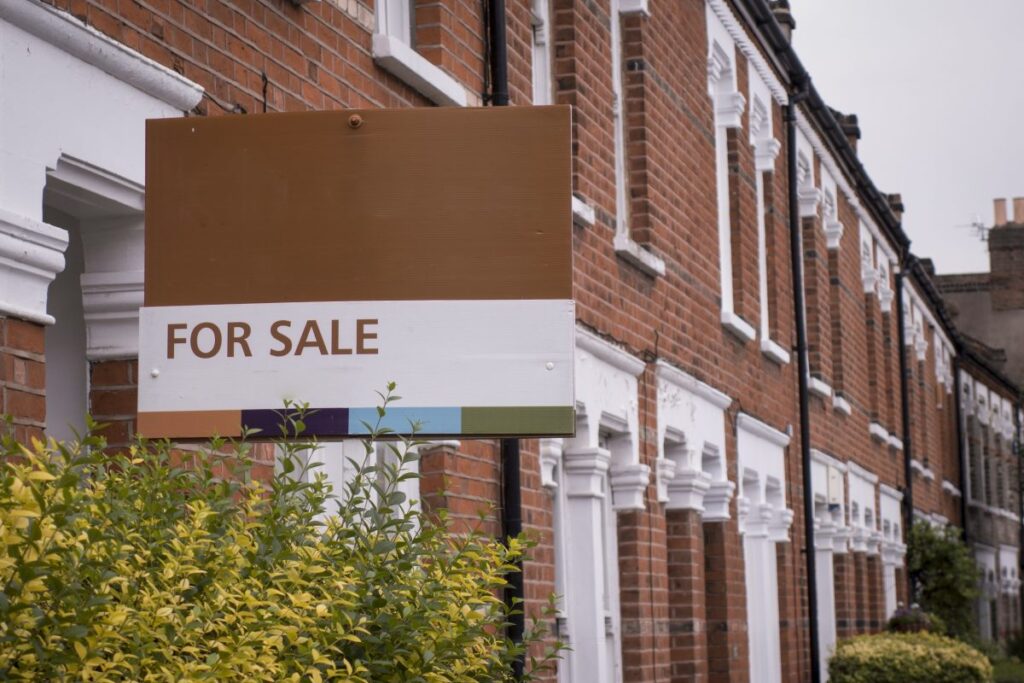 A for sale sign outside a terrace house. Image used in the Stamp duty holiday announced for Northern Ireland buyers blog post