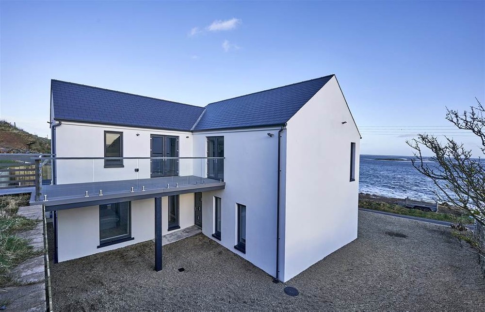 The exterior of 25 Rocks Road. This is a detached house for sale in Ballyhornan. The Irish Sea can be seen in the background. Image used in the Top 20 properties of 2020 blog post.